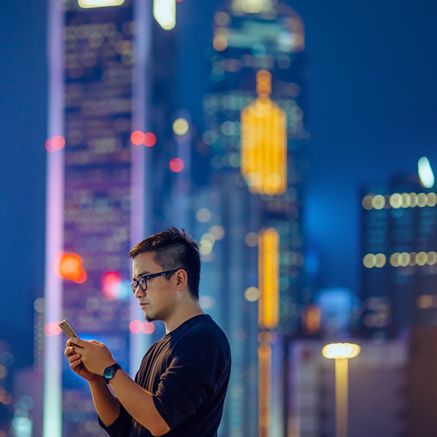 man on phone against cityscape at night